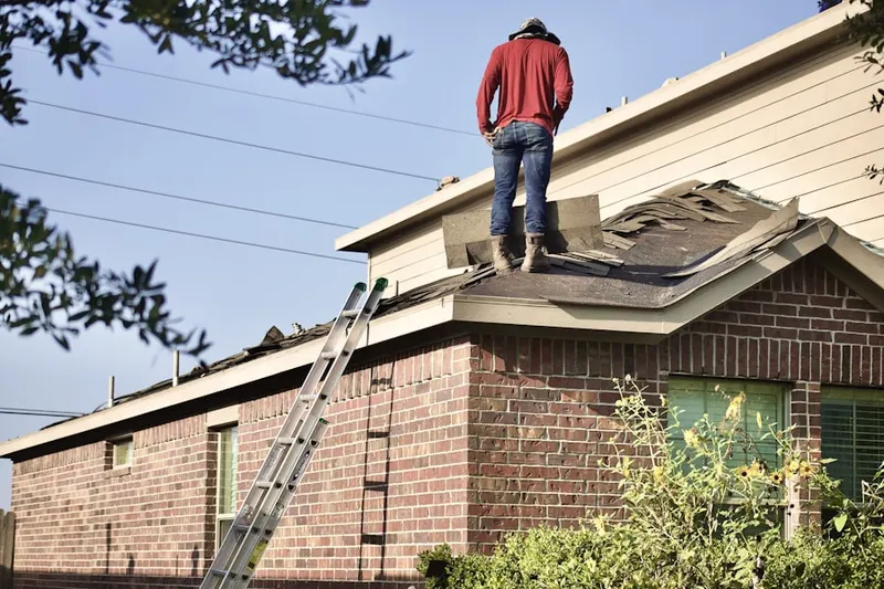 Professional roofer working on a residential roof in Newark